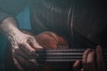 Hands of a man playing the ukulele. Royalty Free Stock Photo