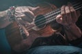 Hands of a man playing the ukulele. Royalty Free Stock Photo