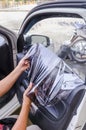 Hands of man removing old car window film Royalty Free Stock Photo