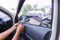 Hands of man removing old car window film Royalty Free Stock Photo