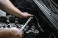 Hands of a man repairing a car engine at shallow depth of field Royalty Free Stock Photo