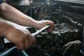 Hands of a man repairing a car engine at shallow depth of field Royalty Free Stock Photo