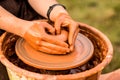 Potter work with clay. Hands of man in shape of heart in clay on pottery wheel mold vase. Royalty Free Stock Photo