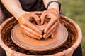 Potter work with clay. Hands of man in shape of heart in clay on pottery wheel mold vase. Royalty Free Stock Photo