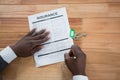 Hands of a man signing insurance document Royalty Free Stock Photo