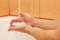 Hands of man with soap under the water in bathroom Royalty Free Stock Photo