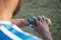 Hands, man or soccer player with smart watch on field to monitor time, training or exercise progress. Wellness