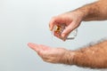 Hands of a man taking alcohol hand sanitizer gel to clean his hands.