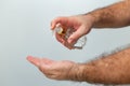 Hands of a man taking alcohol hand sanitizer gel to clean his hands.