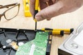 Hands of a man taking apart a broken hard disk. Technology and services Royalty Free Stock Photo