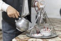 Hands of man tea maker with metal Turkish teapot pouring tea into glass cups in a coffee house in Turkey Royalty Free Stock Photo