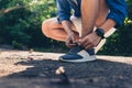 Hands of man tying laces running shoes before get jogging