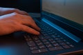 Hands of a man typing on a laptop keyboard. A man working on a laptop. Selective focus Royalty Free Stock Photo