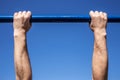 Hands of man which is is tightened on a horizontal bar a blue sky Royalty Free Stock Photo