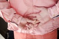 Hands of a man who removes a golden, wedding ring behind back to hide his marital status from mistress.