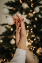 Hands of a man and a woman against the background of a New Christmas tree. The gentle touch of a man and a woman. Love connection