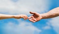 Hands of man and woman on blue sky background. Lending a helping hand. Solidarity, compassion, and charity, rescue Royalty Free Stock Photo