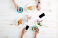 Hands of man and woman eating croissants with coffee Royalty Free Stock Photo