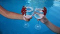 the hands of a man and a woman are holding glasses with a non-alcoholic refreshing summer cocktail on the background of Royalty Free Stock Photo