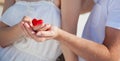 Hands of man and woman holding red heart Royalty Free Stock Photo
