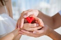 Hands of man and woman holding red heart Royalty Free Stock Photo