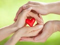 Hands of man and woman holding red heart Royalty Free Stock Photo