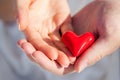 Hands of man and woman holding red heart Royalty Free Stock Photo