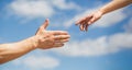 Hands man and woman reaching to each other, support. Giving a helping hand. Hands of man and woman on blue sky Royalty Free Stock Photo