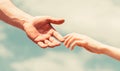 Hands of man and woman reaching to each other, support. Giving a helping hand. Hands of man and woman on blue sky Royalty Free Stock Photo