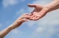 Hands of man and woman reaching to each other, support. Solidarity, compassion, and charity, rescue. Giving a helping Royalty Free Stock Photo