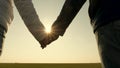 Hands of man and woman at sunset. sunny glare through palms. loving couple holding hands at sunset. Extend your hand to Royalty Free Stock Photo