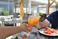 Hands of man and women with glasses of juice in the hands in a restaurant Royalty Free Stock Photo