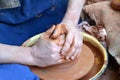 Hands of the man work with clay on a potter`s wheel Royalty Free Stock Photo