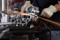 Hands man work in home workshop garage with angle grinder, goggles and construction gloves, sanding metal makes sparks closeup, Royalty Free Stock Photo