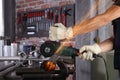 Hands man work in home workshop garage cut metal pipe, with construction gloves, cutting metal makes sparks closeup, diy and craft Royalty Free Stock Photo