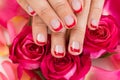 Hands With Manicured Nail Varnish Placed On Roses