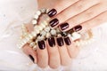 Hands with manicured nails colored with dark purple nail polish Royalty Free Stock Photo