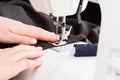 Sewing machine in action with hands guiding fabric during a creative crafting session Royalty Free Stock Photo