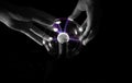 Hands manipulating a crystal ball