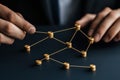 Hands manipulating a network structure, dark isolate background