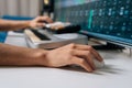 Hands manipulating synthesizer midi keyboard and computer keyboard while controlling daw on screen with faders and Royalty Free Stock Photo