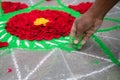 Hands of mans making rangoli - indian flower mandala. Indian tourism. Indian traditional culture, art and religion