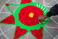 Hands of mans making rangoli - indian flower mandala. Indian tourism. Indian traditional culture, art and religion