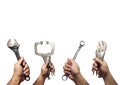 The hands of many mechanic holding instruments, tools isolated o