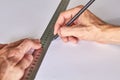 Hands marking a white board, ruller and pencil on a green mat Royalty Free Stock Photo