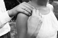 Hands of married couple with rings. Black and white photo.