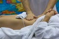 Hands of a massage therapist doing a massage to a girl Royalty Free Stock Photo