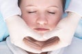 Hands of a massage therapist working on the neck and face area, top view Royalty Free Stock Photo