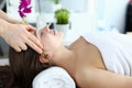 Hands massage whiskey to girl who lying on towel Royalty Free Stock Photo