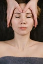 Client receiving relaxing face massage at asian beauty clinic. Top view Royalty Free Stock Photo